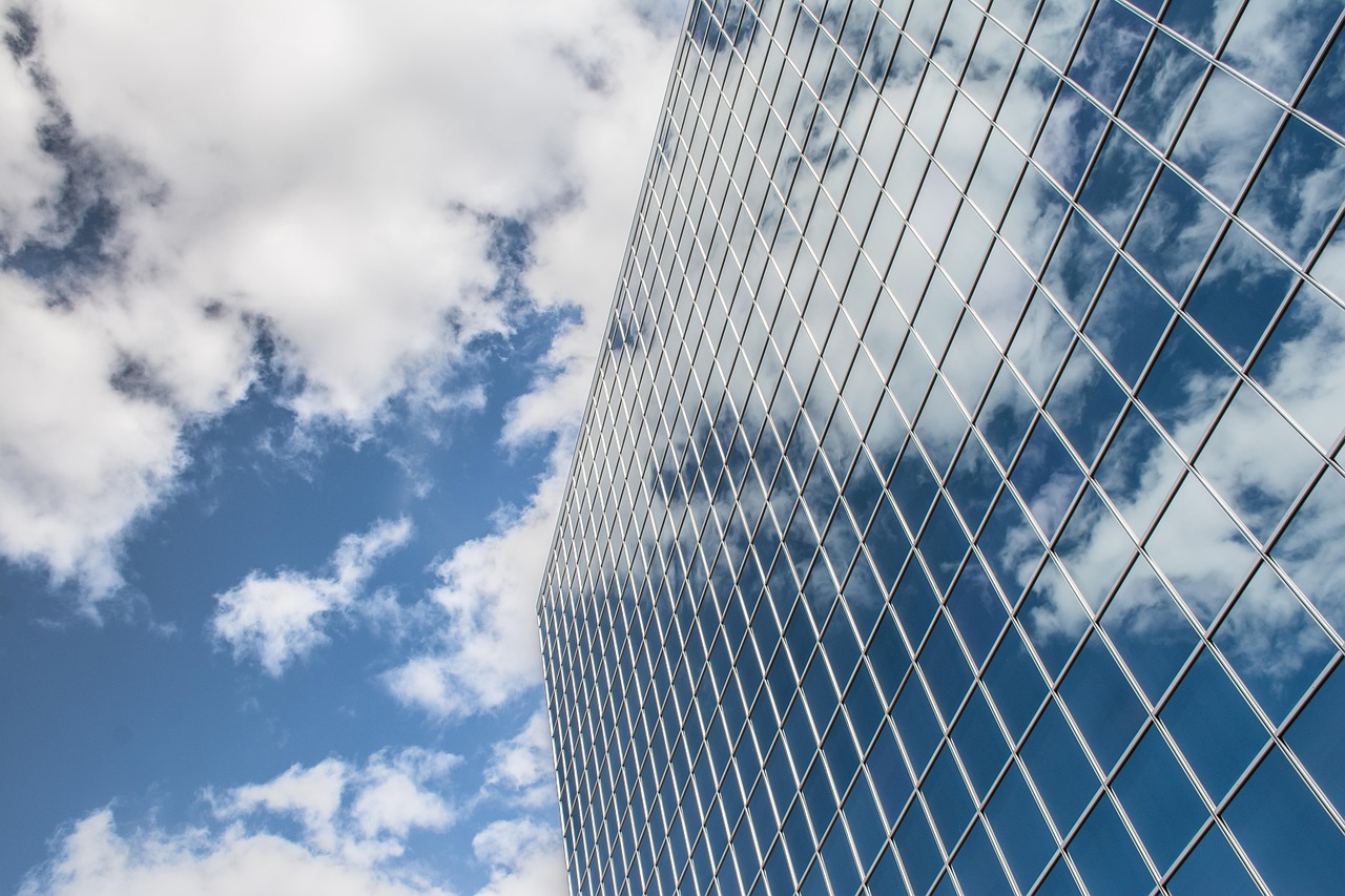 Building, reflection, clouds — Suspended Stages: Custom Solutions for Rolling Ladders and Roof Anchors