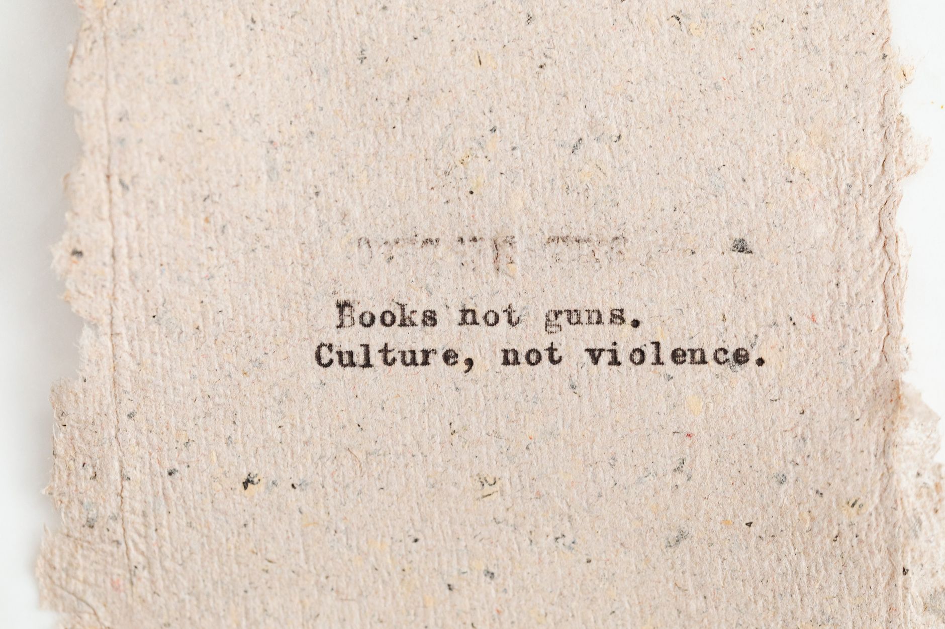 Close-up of typewritten text promoting books over guns and culture over violence. — The Evolution of Casino Loyalty Programs