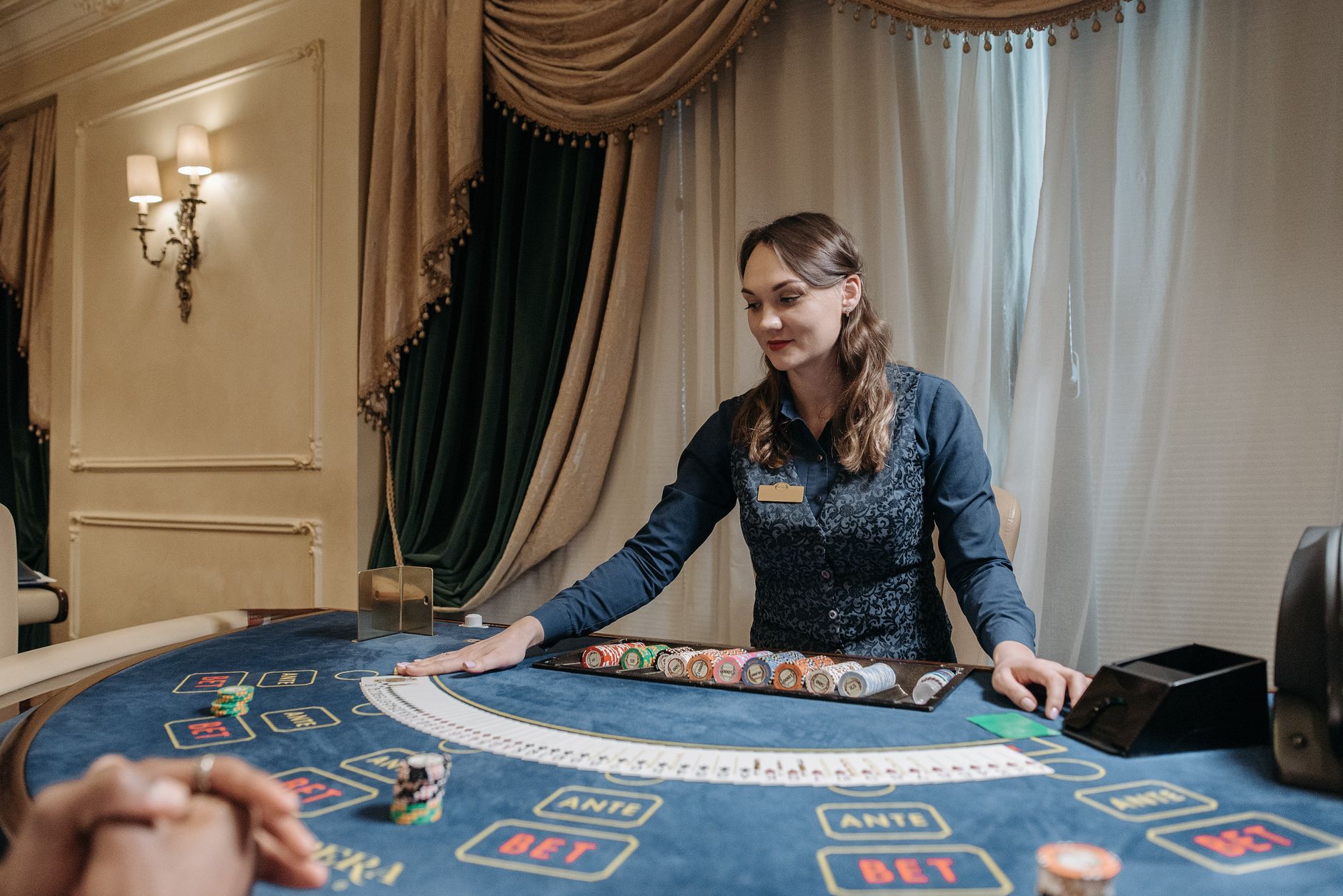Casino dealer managing cards and chips in an elegant gambling setting. — The Evolution of Casino Loyalty Programs