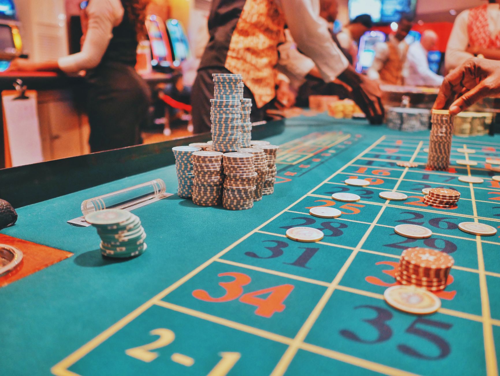 A vibrant view of a casino roulette table with poker chips and players engaged in gambling. — The Evolution of Casino Loyalty