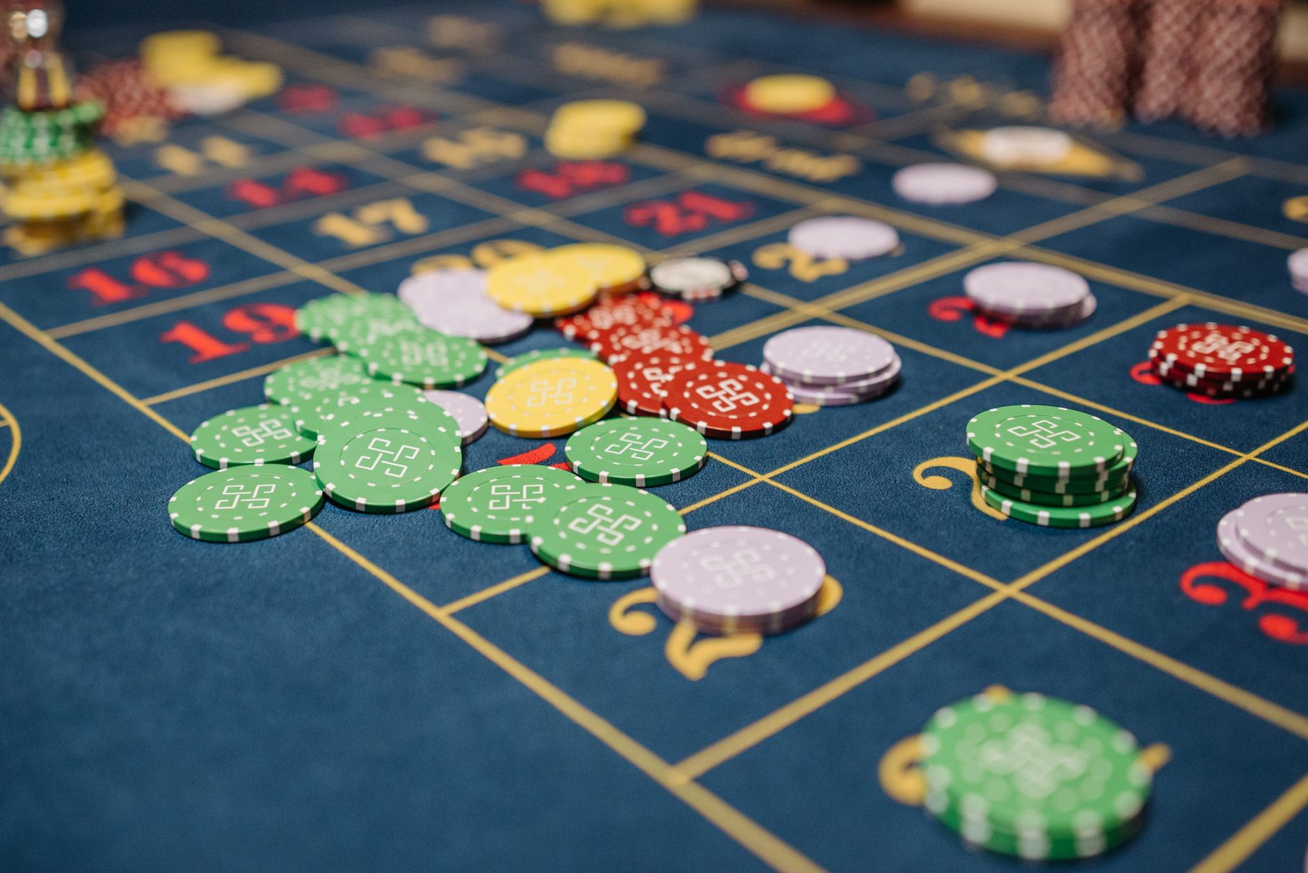 Closeup of colorful casino chips scattered on a roulette table. — The Impact of Artificial Intelligence on Casino Operations