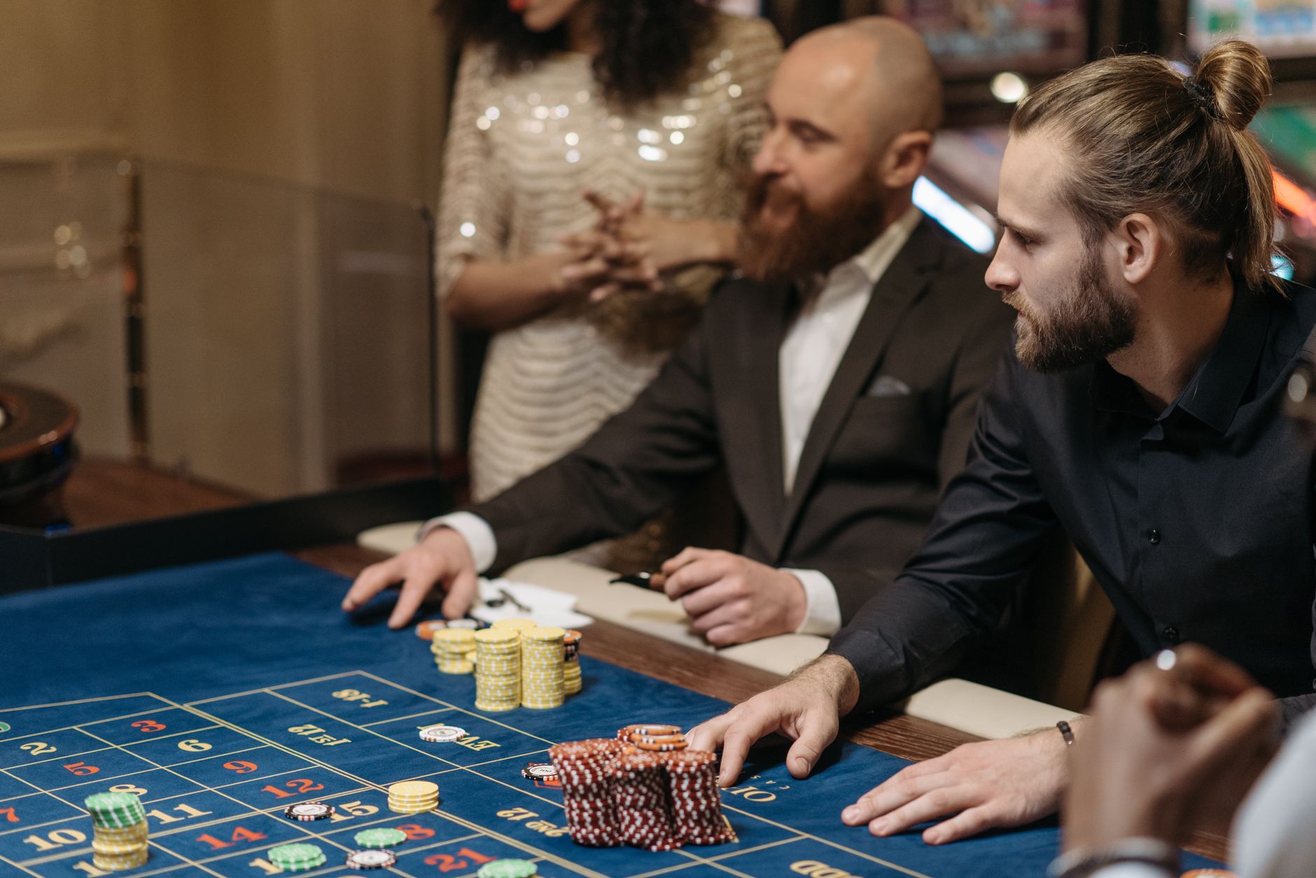 Group of adults enjoying a thrilling roulette game at a casino table. — The Influence of Artificial Intelligence on Casino Op