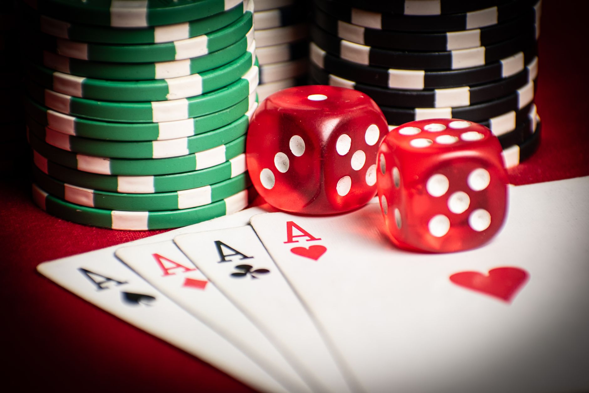 Close-up of poker hand with dice and chips, symbolizing casino gaming. — The Rise of Live Dealer Games in Online Casinos